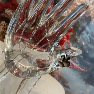 Set of "I Love You" engraved stainless steel couple rings with necklaces.